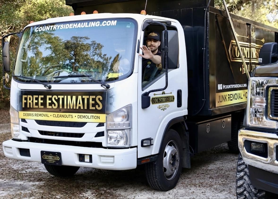 Countryside Hauling Isuzu NPR dump truck arriving in a Tallahassee driveway ready for junk removal